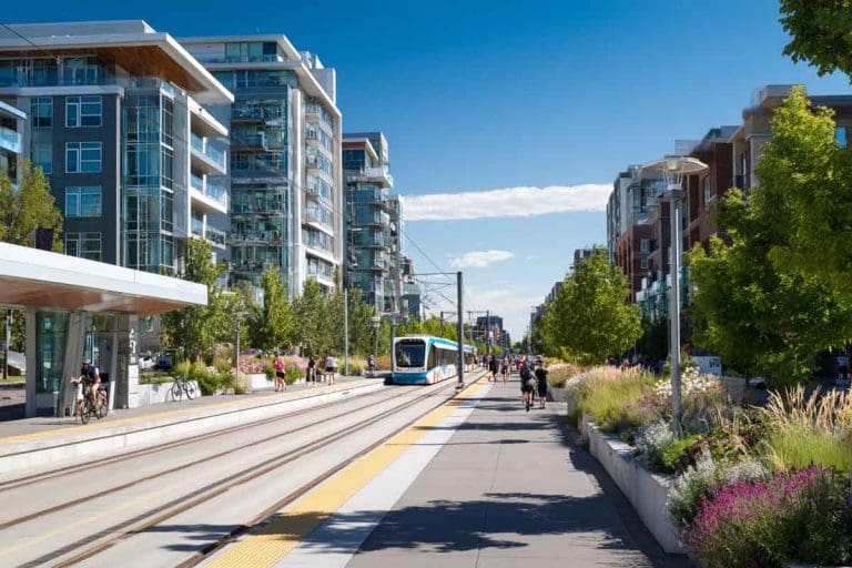 senthi2034 A modern Calgary urban neighborhood with a visible ctrain - Real Estate News Blog A_modern_Calgary_urban_neighborhood_with_a_visible_ctrain